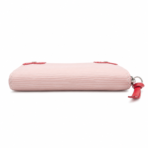 A light pink textured leather pouch with red leather strap accents and silver-tone hardware, shown from a side profile on a white background.