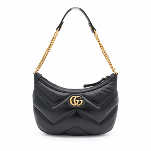 A black quilted leather shoulder bag with a gold-tone interlocking G logo on the front, featuring a gold chain strap and black leather shoulder strap on a white background.
