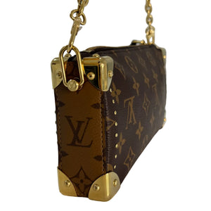 A Louis Vuitton monogram canvas shoulder bag with gold-tone hardware and chain strap, shown from a side angle on a light surface.