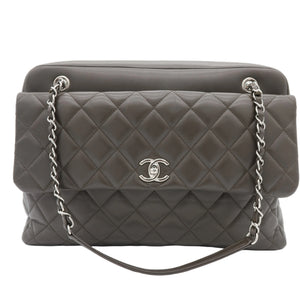 A dark gray quilted leather shoulder bag with silver-tone chain strap and a silver interlocking CC logo on the front, photographed against a plain white background.