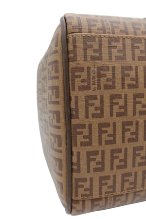Close-up of a Fendi handbag in brown and beige Fendi Zucca monogram canvas, showing the side panel and edge stitching against a white background.