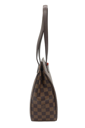 A Louis Vuitton shoulder bag in the Damier Ebene checkered canvas, shown from a side profile view against a white studio background.