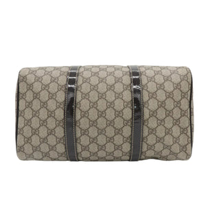 A vintage Gucci monogram canvas shoulder bag with dark brown patent leather trim, shown against a plain white background.