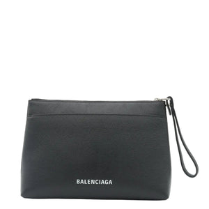 A black textured leather zip pouch clutch with a wrist strap, featuring the white 'BALENCIAGA' logo on the front, set against a plain white background.