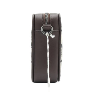 A dark brown leather Valentino crossbody bag shown from the back, featuring a white hangtag with the red Valentino logo and brand name, set against a plain white background.