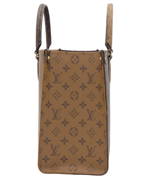 A Louis Vuitton monogram canvas shoulder bag in brown, featuring the classic LV monogram pattern and dark brown leather handles, shown against a plain white background.