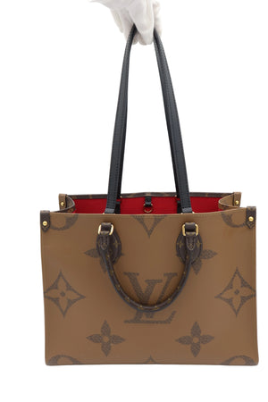 A Louis Vuitton monogram tote bag in brown coated canvas with dark brown leather handles and a bright red interior lining, held by a hand wearing a white glove against a white background.