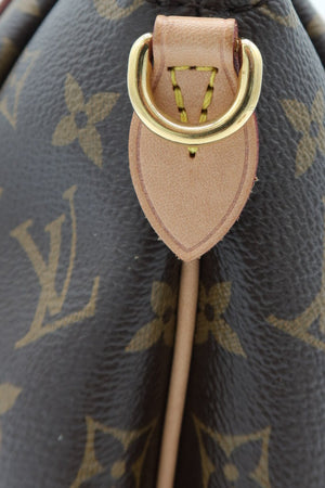 Close-up of a Louis Vuitton monogram handbag showing the dark brown coated canvas with tan monogram print, light tan leather trim, and gold-tone hardware.