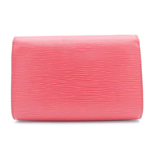 A pink textured leather clutch wallet with a horizontal grain pattern, shown from the front on a plain white background.