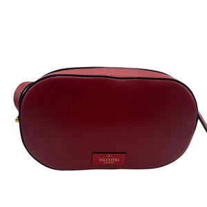 Red handbag with a visible brand label on a white background