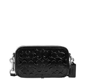 Black quilted handbag with brand logo on a light gray background