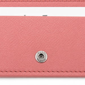 Gucci Pink Leather Card Holder Wallet with Interlocking GG Logo & Snap Closure – a close-up of a pink textured leather