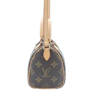 Louis Vuitton monogram mini Speedy bag in brown coated canvas with tan leather trim and shoulder strap, shown against a plain white background.