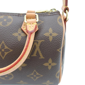 Close-up of a Louis Vuitton monogram handbag in brown coated canvas with tan leather trim and gold-tone hardware, shown against a white background.