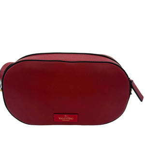 Red handbag with a visible brand logo on a light gray background