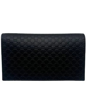 Black quilted clutch bag on a white background