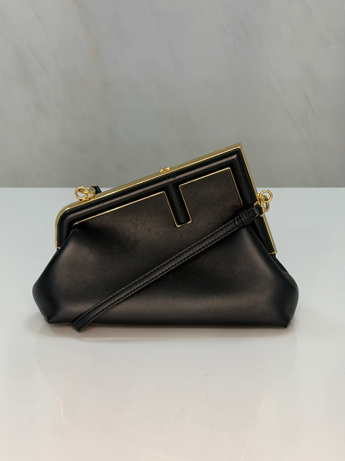 Fendi First Small Clutch – Black Leather, Gold Frame Detail (Pre-Owned)