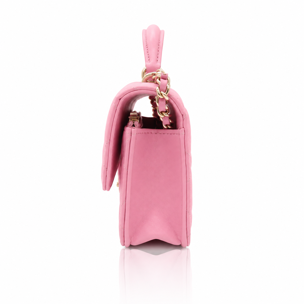 Chanel Mini Top Handle Rectangular Flap Bag in pink lambskin right side view, featuring a gold chain strap and a top handle, set against a clean white background with a subtle reflection.