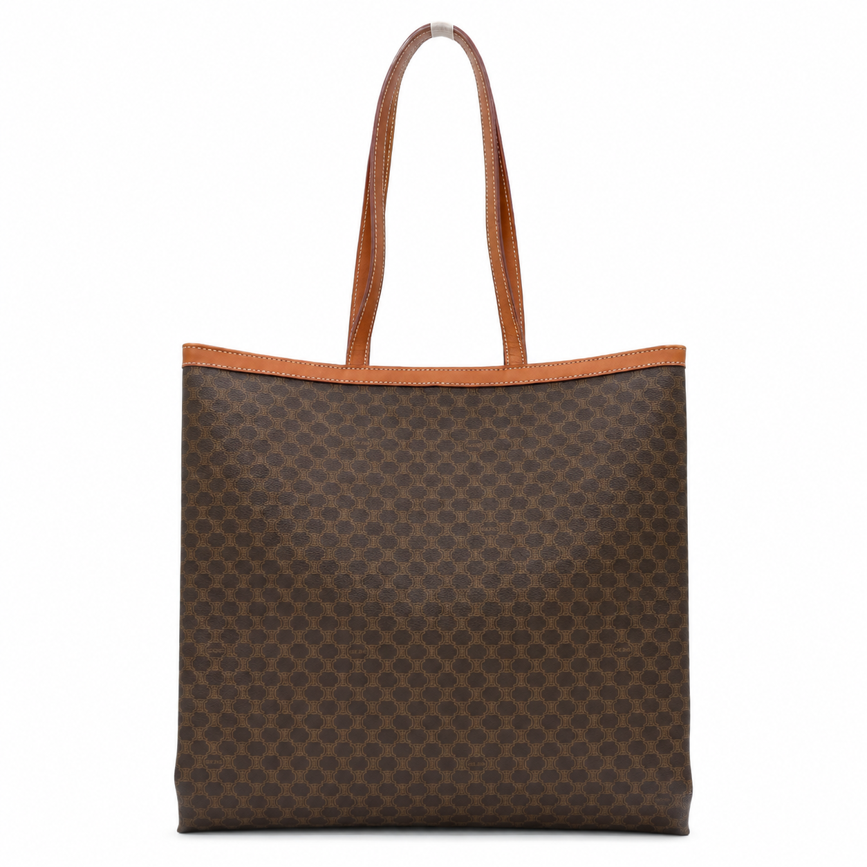 A brown monogram canvas tote bag with tan leather handles and trim, shown against a plain white background.
