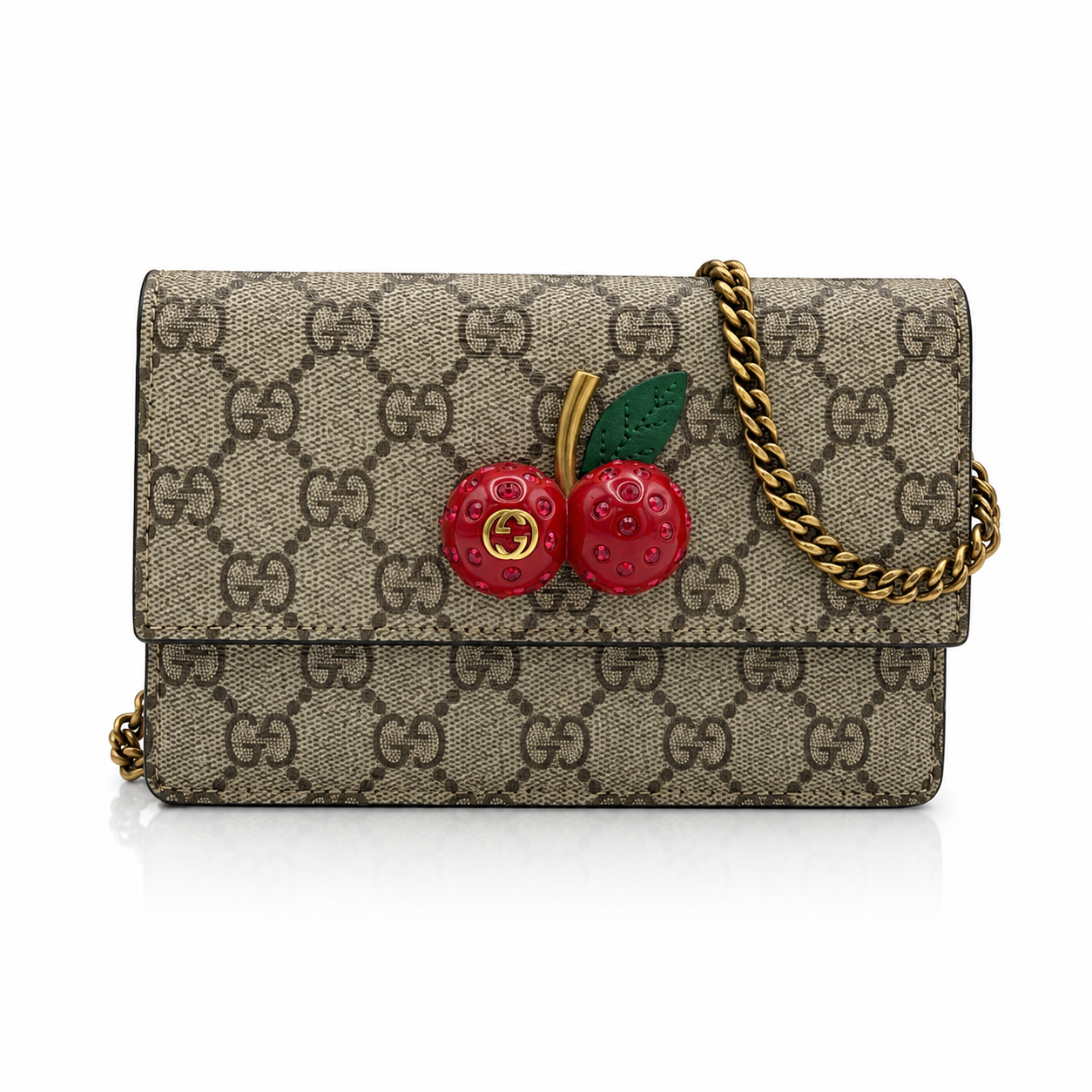 Gucci GG Supreme Monogram Mini Cherry Chain  shoulder bag with a gold chain strap and a 3D cherry embellishment on the front, shown on a white background.