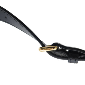 Close-up of a black leather strap with a polished gold-tone metal buckle engraved with the brand name 'YASUHIRO'.