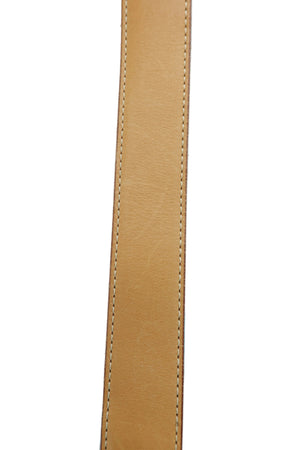 Close-up of a tan leather strap with neat contrast stitching, positioned vertically against a light blue background.