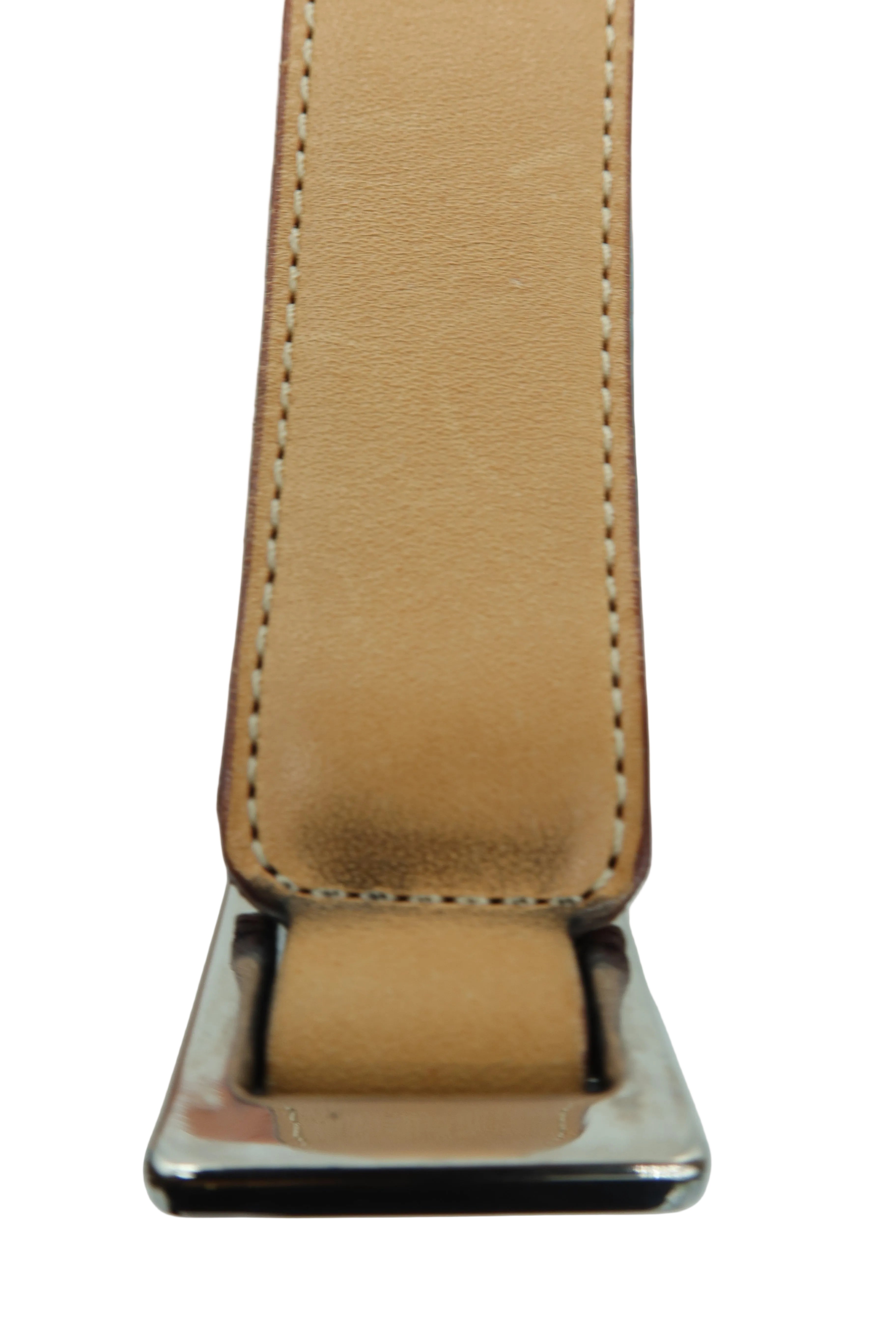 Close-up of a tan leather belt strap with white stitching and a polished silver-tone metal buckle, shown against a light gray background.