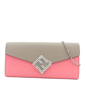 A color-blocked clutch bag with a light gray flap and a pink body, featuring a silver-tone geometric logo clasp and a silver chain strap, set against a plain white background.