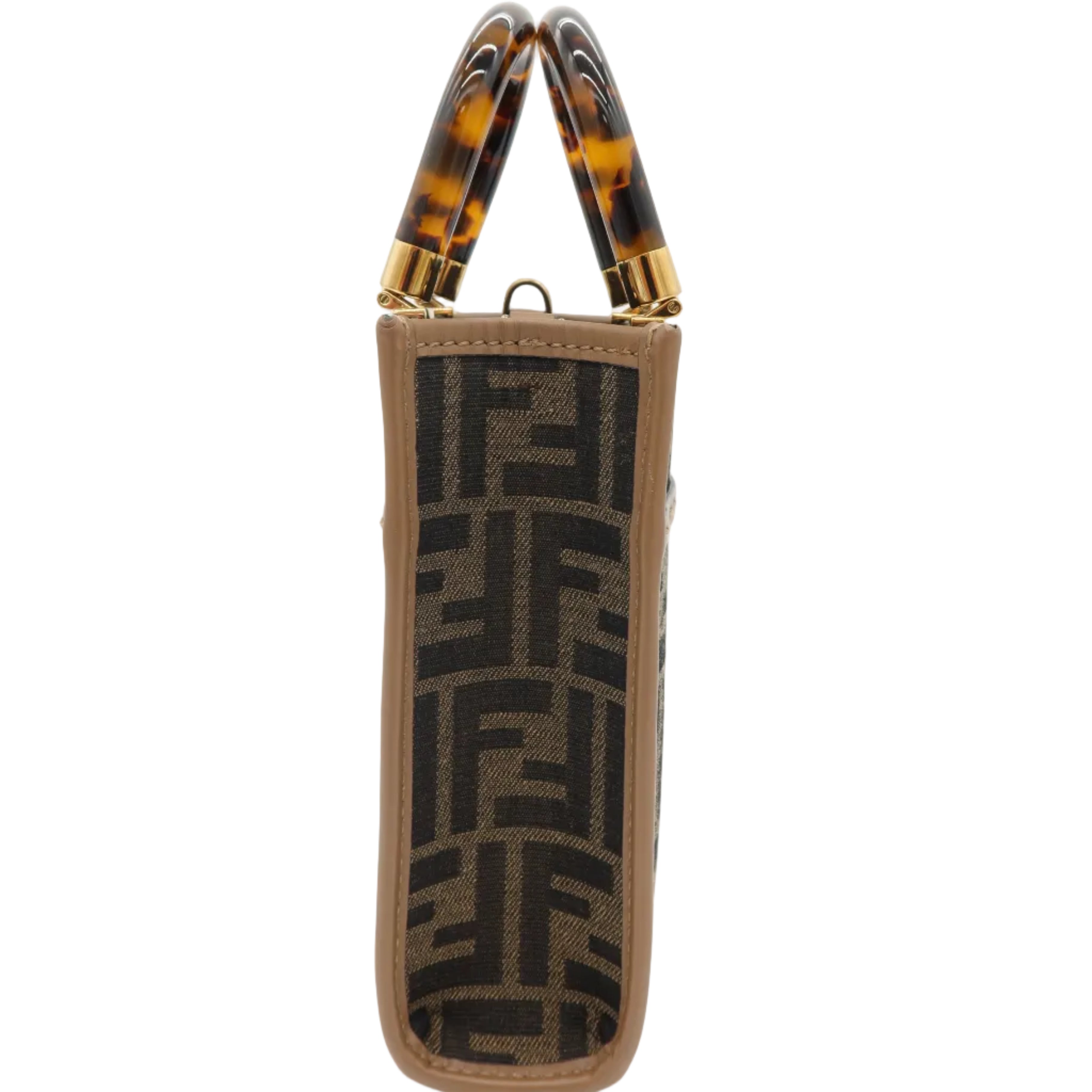 A Fendi handbag shown from the side against a white background, featuring the signature brown and black FF monogram canvas body, tan leather trim, and distinctive tortoiseshell top handles with gold-tone hardware.
