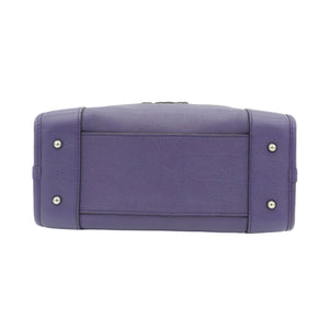 A purple leather clutch bag with silver-tone studs on the sides, photographed from the back against a plain white background.