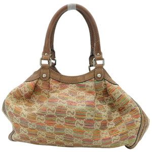 A vintage Gucci shoulder bag featuring the brand's signature GG monogram canvas in beige, orange, and brown, with brown leather handles and trim.