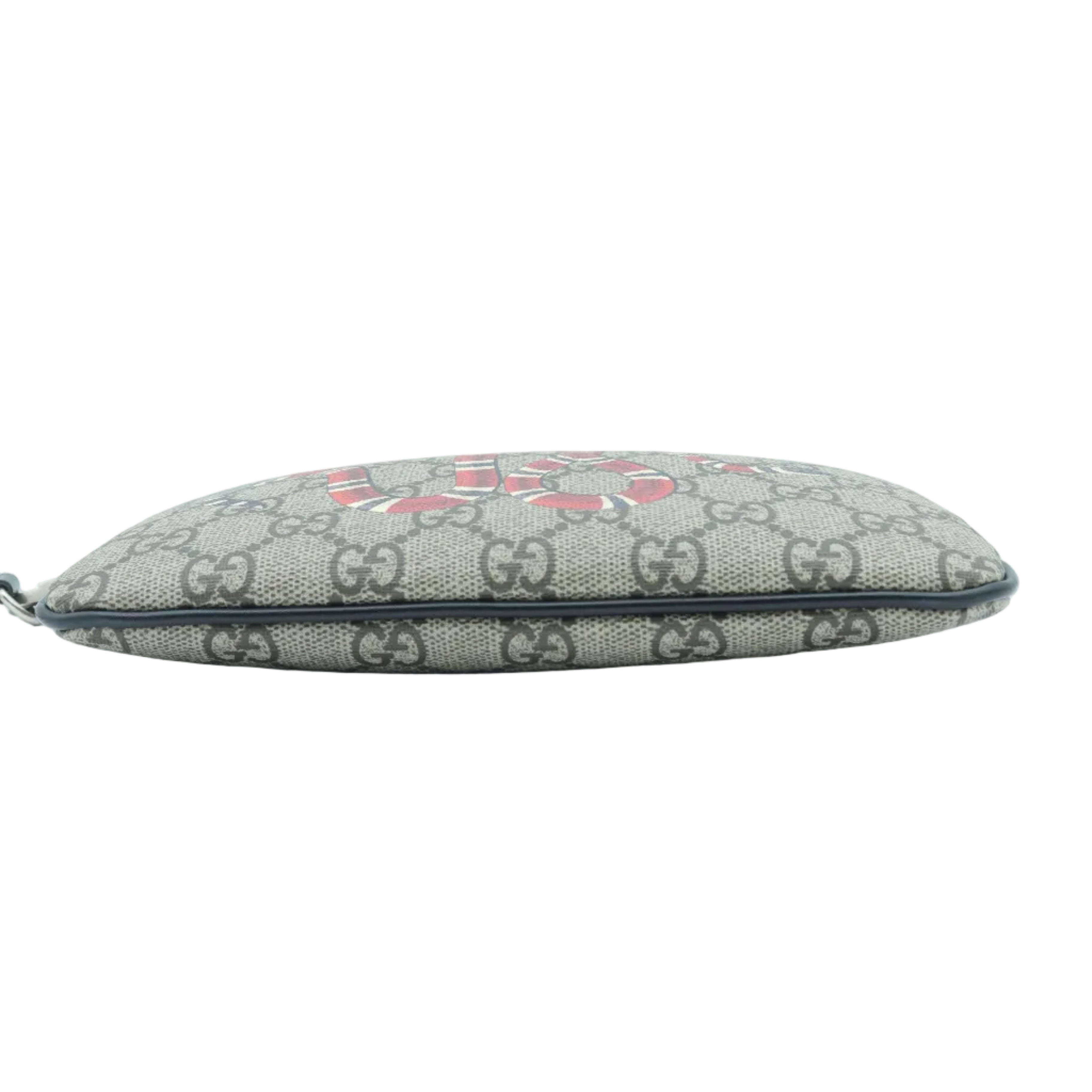 A small Gucci zippered pouch in beige GG Supreme canvas with a red GG logo and dark brown trim, shown against a plain white background.