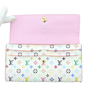 A Louis Vuitton monogram wallet or clutch shown open on a white background, with a pink interior flap and a cream exterior covered in multicolored LV monogram motifs.