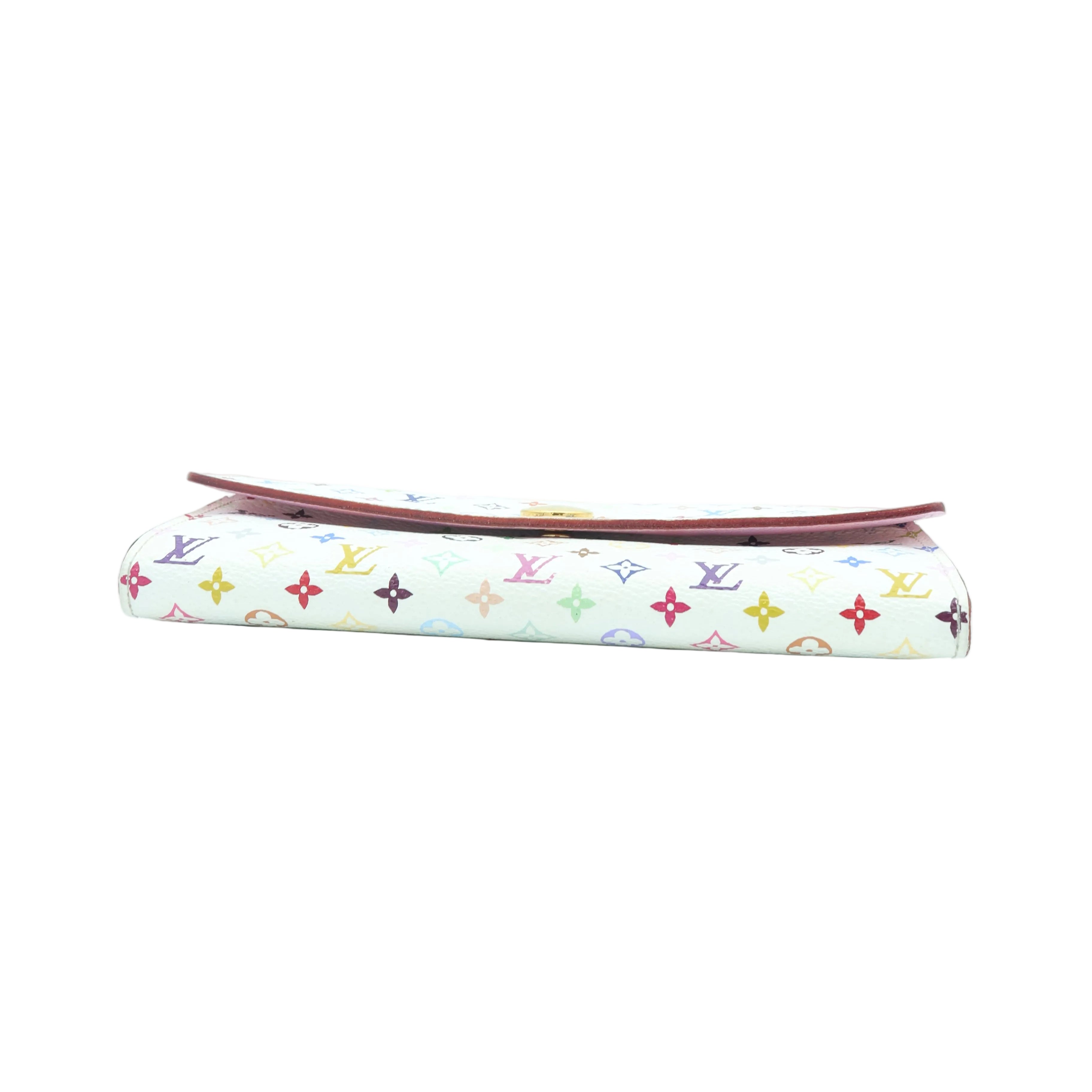 A folded Louis Vuitton monogram canvas clutch or wallet with a white background and multicolor LV logo print, featuring a reddish-brown leather edge visible along the top, set against a plain white background.
