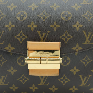 Close-up of a Louis Vuitton monogram canvas bag with a gold-tone clasp closure on a white background.