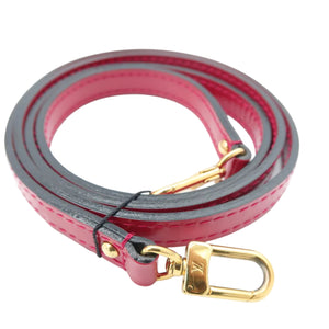 A red leather shoulder strap with gold-tone hardware, including a lobster clasp and a ring, coiled on a white background.