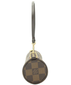 A Louis Vuitton cylindrical shoulder bag in the Damier Ebene canvas, featuring a brown and beige checkered pattern, a dark brown leather strap, and gold-tone hardware, shown against a plain white background.