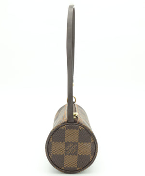 A Louis Vuitton cylindrical shoulder bag in the Damier Ebene canvas, featuring a brown and beige checkered pattern with a dark brown leather strap and gold-tone hardware, shown against a plain white background.