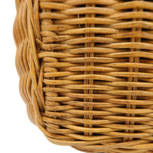 Close-up of a woven wicker basket corner showing the natural tan-brown material texture on a white background.
