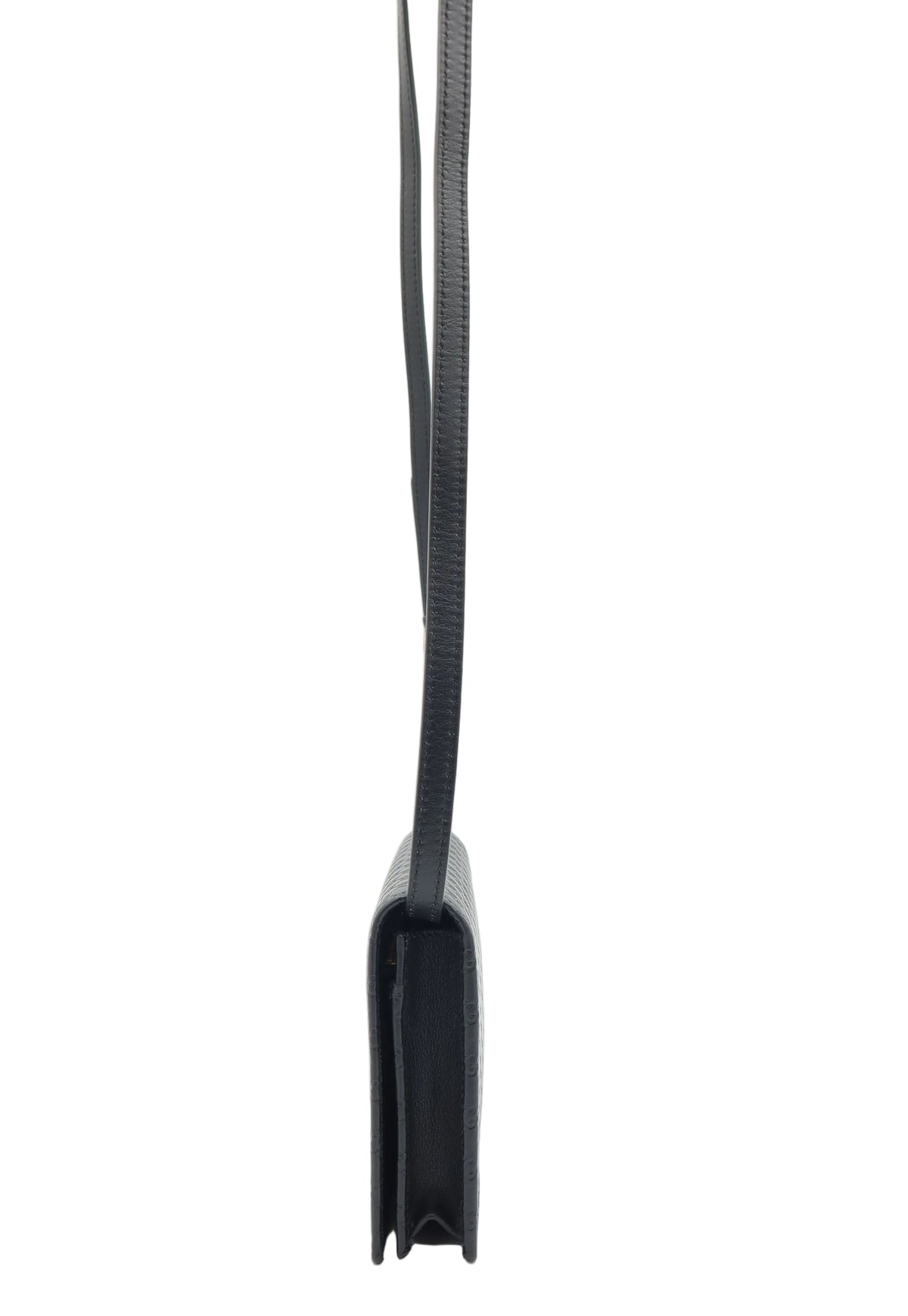 A black leather shoulder bag shown from a side profile view, featuring a thin black woven strap, set against a plain white background.