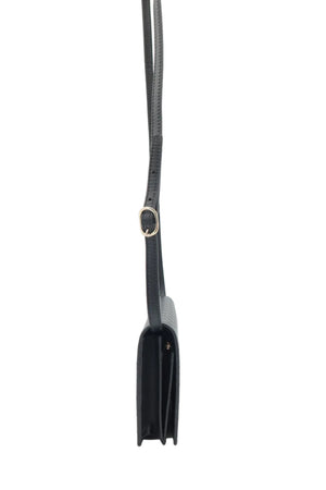 A black leather shoulder bag shown from a side profile view, featuring a thin black strap with a gold-tone metal ring connector, set against a plain white background.