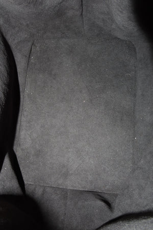 A close-up view of a dark gray suede or microfiber fabric surface with a rectangular patch of the same material in the center.