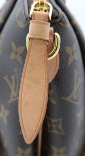 Close-up of a Louis Vuitton monogram handbag in dark brown coated canvas with tan leather trim and gold-tone hardware.