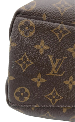 Close-up of a brown monogram canvas bag corner showing the classic Louis Vuitton LV logo and floral motifs in tan on a white background.