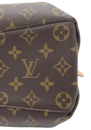 Close-up of a brown monogram canvas bag corner showing the classic Louis Vuitton LV logo and floral motifs on a white background.