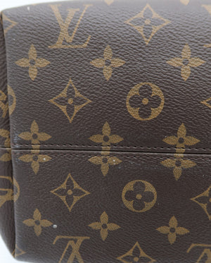 Close-up of a brown monogram canvas bag with tan Louis Vuitton-style LV and floral motifs, showing part of the body and a horizontal seam.
