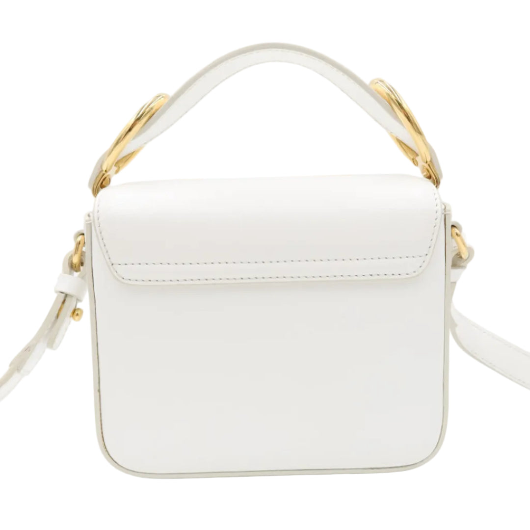 A white faux leather top-handle crossbody bag with gold-tone hardware and a matching white shoulder strap, shown against a plain white background.