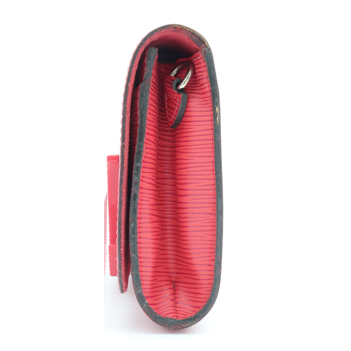 A red textured leather clutch or wallet shown from the side on a plain white background.