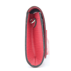 A red textured leather card holder or wallet shown from the back, featuring a black leather trim and a silver metal ring, on a solid white background.