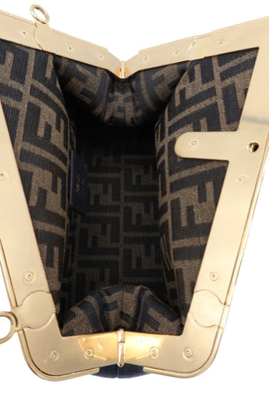 Close-up of the interior of a Fendi handbag, showing the signature brown and black FF monogram canvas lining and a polished gold-tone metal frame.